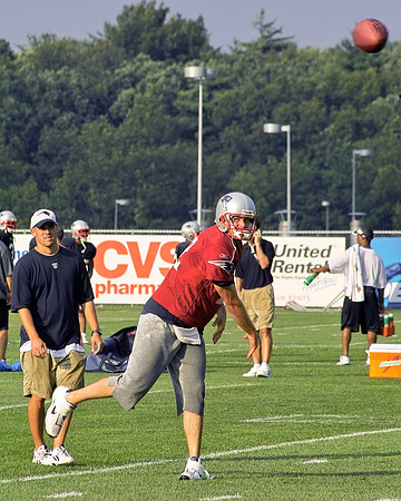 Tom Brady fires a pass as OC Josh Mcdaniels looks on.